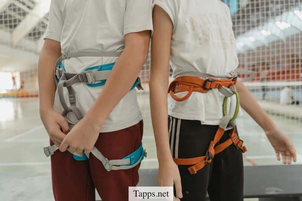 Person in White T-shirt With Brown and Blue Leather Sling Bag