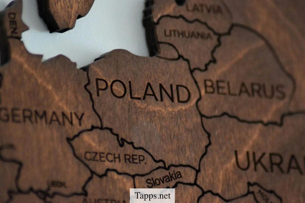 Detailed wooden map featuring Poland and surrounding countries.