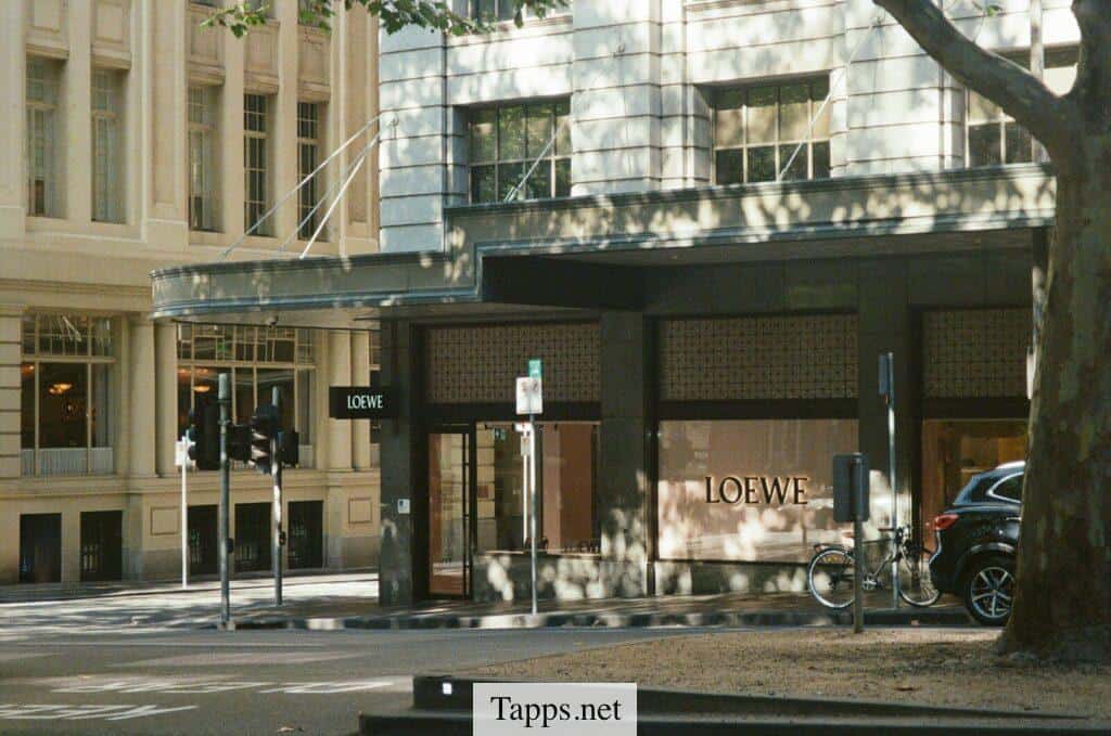 Storefront with loewe logo on a city street.