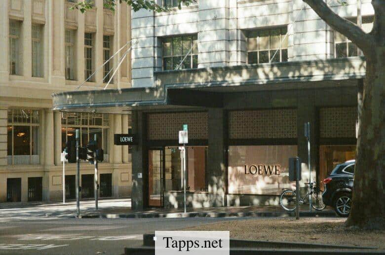 Storefront with loewe logo on a city street.
